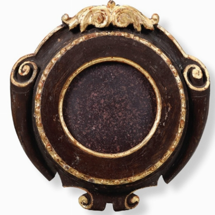 A porphyry plaque in a wood frame