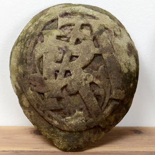 Early carved armorial initial stones