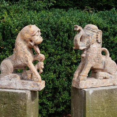 Ancient hand carved stone statues of a tiger and an elephant